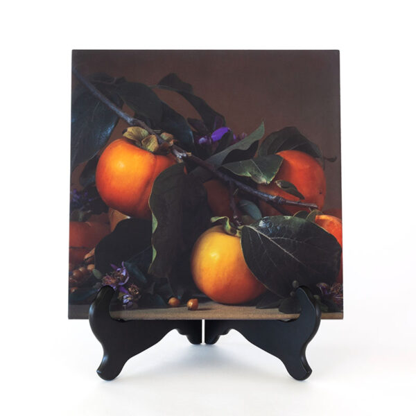 Photo of the Fuyu Persimmons 12 inch Ceramic Art Piece on a black tabletop easel
