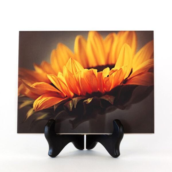 Photo of Yellow Sunflower printed on a ceramic tile. The ceramic tile is displayed on a black tabletop easel.
