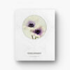Pictured: The back cover of the notebook. The white background has a decorative pattern screened lightly on it. On top of the design, there is a photo of two white and purple anemones in a circle.