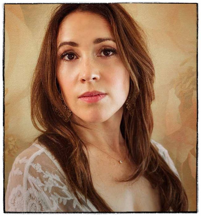 Portrait of woman against cream background